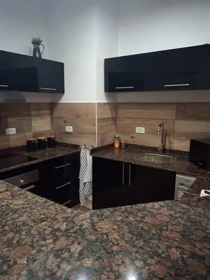 a kitchen with granite counter tops and a sink at Alena Lempachova in Hurghada