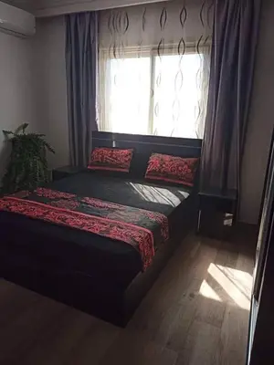 a bedroom with a bed in front of a window at Alena Lempachova in Hurghada