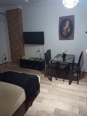 a living room with a table and a dining room at Alena Lempachova in Hurghada