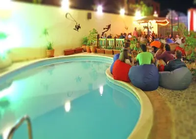 a group of people sitting around a swimming pool at L'Oasis de Safaga Hotel in Hurghada