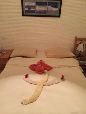 a bed with two towels and flowers on it at L'Oasis de Safaga Hotel in Hurghada