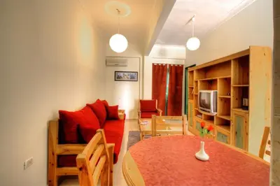 a living room with a table and a couch at L'Oasis de Safaga Hotel in Hurghada