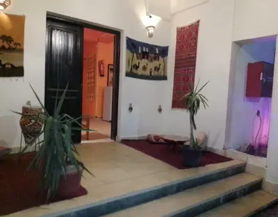 a hallway with two potted plants next to a door at L'Oasis de Safaga Hotel in Hurghada