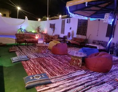 a stage with chairs and a rug on the ground at L'Oasis de Safaga Hotel in Hurghada