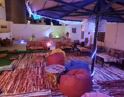 a living room with couches and a stage with lights at L'Oasis de Safaga Hotel in Hurghada