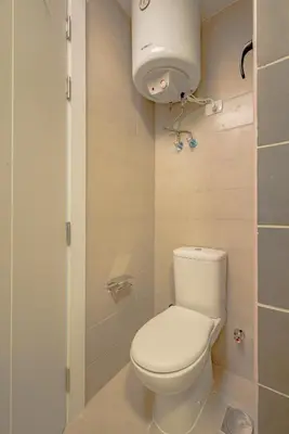 a bathroom with a white toilet and a shower at Modern 1-Bedroom Apartment in G-Cribs, El Gouna, pool access in Hurghada
