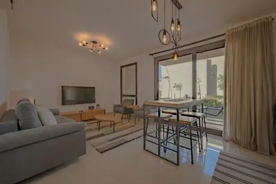 a living room with a couch and a table at Modern 1-Bedroom Apartment in G-Cribs, El Gouna, pool access in Hurghada