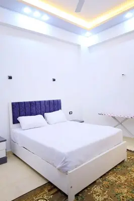 a white bedroom with a large white bed at Tomorrow Land villa in Luxor