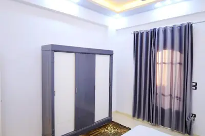 a dressing room with a mirror and a curtain at Tomorrow Land villa in Luxor