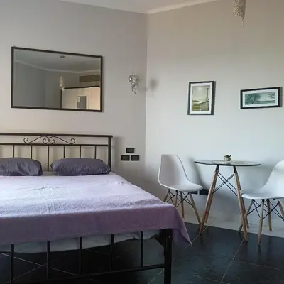 a bedroom with a bed and a table and a mirror at Tony's Privy Beds by Red Sea in Hurghada