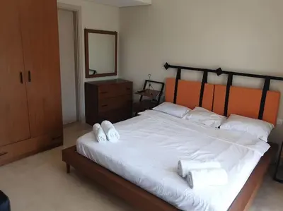 a bedroom with a large bed with white towels on it at Mangroovy - 1BR Glamorous Gouna view condo in Hurghada