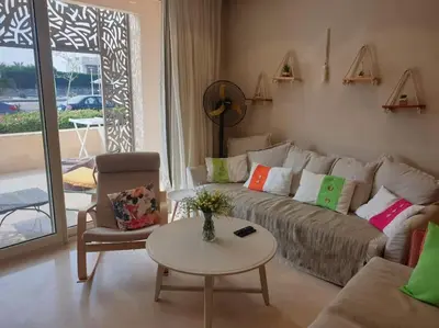 a living room with a couch and a table at Mangroovy - 1BR Glamorous Gouna view condo in Hurghada