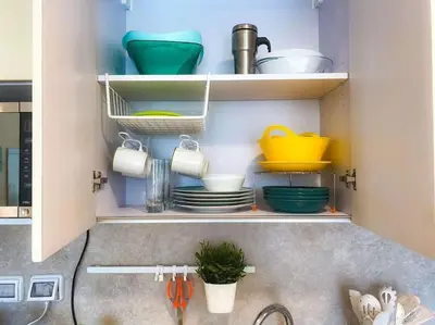 a kitchen with a sink with plates and utensils at Mangroovy - 1BR Glamorous Gouna view condo in Hurghada