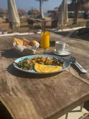 a plate of food on a table with a plate of food at Mangroovy Ritzy, Cerulean appartement by the pool in Hurghada