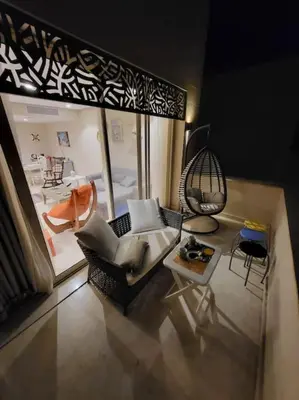 a living room with a couch and a table at Mangroovy - 2BR Marvelous Pool View Apartment in Hurghada