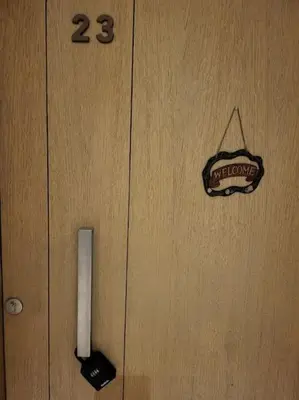 a door with a door knob and a sign on it at Mangroovy - 2BR Marvelous Pool View Apartment in Hurghada