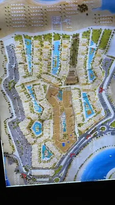 a map of a resort with roads and buildings at Mangroovy - 1BR Ravishing Lake and Mountain View in Hurghada