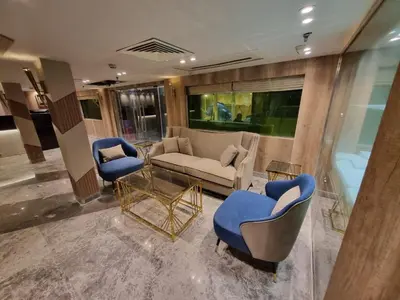 a living room with a couch and two chairs at Nile Cruise 3 & 4 & 7 Nights in Luxor