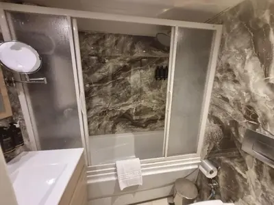 a bathroom with a shower and a sink at Nile Cruise 3 & 4 & 7 Nights in Luxor