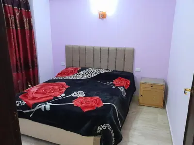a bedroom with a bed with red roses on it at 2-Bed - Sleeps 4 - Pet Friendly w Parking in Hurghada