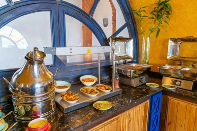 a kitchen with bowls of food on a counter at Sonesta Nouba Hotel Aswan in Aswan
