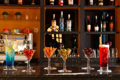 a group of different cocktails on a bar at Sonesta Nouba Hotel Aswan in Aswan