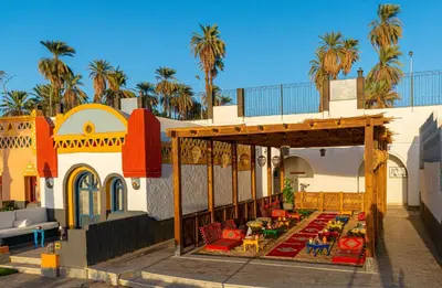 a patio with tables and chairs on a building at Sonesta Nouba Hotel Aswan in Aswan