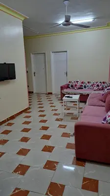 a living room with two couches and a tv at Sweet Home-ممنوع للمصرين Open 24 Hour in Hurghada