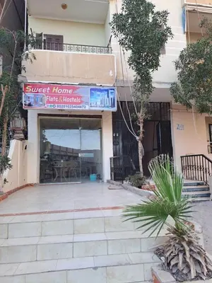 a building with a sign that reads guest home has interests at Sweet Home-ممنوع للمصرين Open 24 Hour in Hurghada