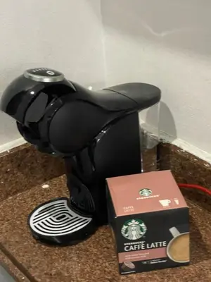 a coffee machine sitting on a counter next to a box at Schöne Ferienwohnung in Cecelia Resort, am Pool und wunderschönen Strand für Familien und Paare in Hurghada