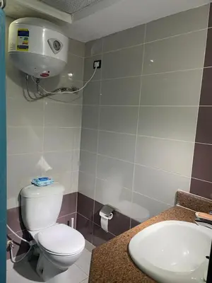 a bathroom with a toilet and a sink at Schöne Ferienwohnung in Cecelia Resort, am Pool und wunderschönen Strand für Familien und Paare in Hurghada