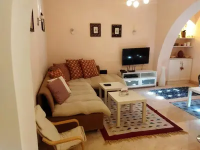 a living room with a couch and a table at Down-Town Kafr El Gouna 1-Bd Ground Floor in El Gouna