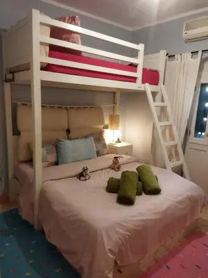 a bedroom with a bunk bed with two cats laying on it at Down-Town Kafr El Gouna 1-Bd Ground Floor in El Gouna