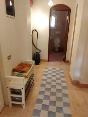 a hallway with a room with a table and a toilet at Down-Town Kafr El Gouna 1-Bd Ground Floor in El Gouna
