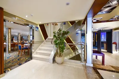 a staircase in a building with a potted plant at Nile Treasure Cruise - 4 or 7 Nights From Luxor each Saturday and 3 or 7 Nights From Aswan each Wednesday in Luxor