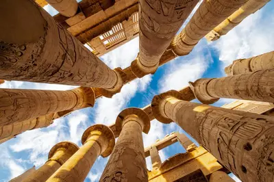 a view of the columns of a building looking up into the sky at Nile Treasure Cruise - 4 or 7 Nights From Luxor each Saturday and 3 or 7 Nights From Aswan each Wednesday in Luxor