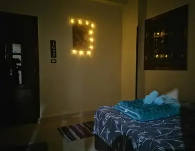a room with a bed and lights on the wall at sun smile guest house᭄ꦿ in Luxor