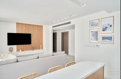 a living room with a couch and a tv on a wall at 3bedroom apartment with a private pool in Hurghada