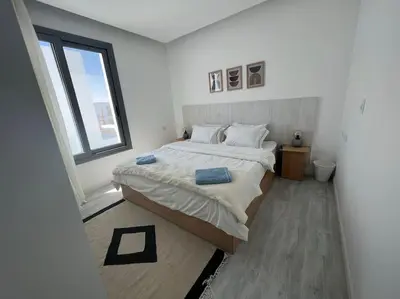 a white bedroom with a large bed and a window at 3bedroom apartment with a private pool in Hurghada