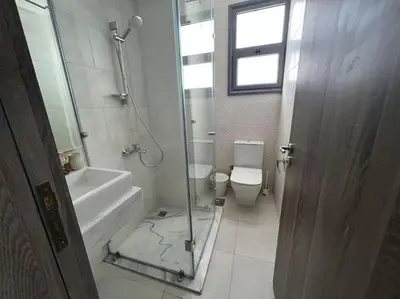 a bathroom with a glass shower and a toilet at 3bedroom apartment with a private pool in Hurghada