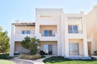 a villa with a view of a building at Ground floor two bedrooms in Joubal Lagoon with direct pool access and view in Hurghada