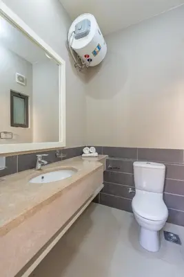 a bathroom with a toilet and a large mirror at Brand-New Family House in Tawila El Gouna Lagoon and Pool Access in Hurghada