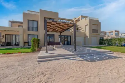 a house on the beach with a wooden structure at Brand-New Family House in Tawila El Gouna Lagoon and Pool Access in Hurghada