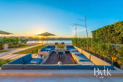 a row of blue couches sitting on a wooden deck at BYTK - La Casa Del Sol in Hurghada