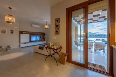 a living room with a sliding glass door and a table at BYTK - La Casa Del Sol in Hurghada
