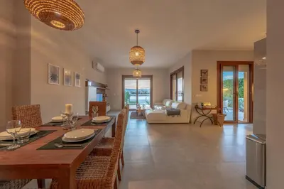 a dining room and living room with a table and chairs at BYTK - La Casa Del Sol in Hurghada