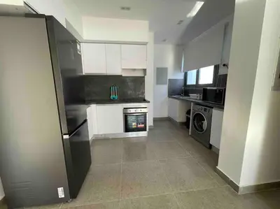 a kitchen with a refrigerator and a stove at 2 bd with private heated pool in Sholan 2 El Gouna in Hurghada