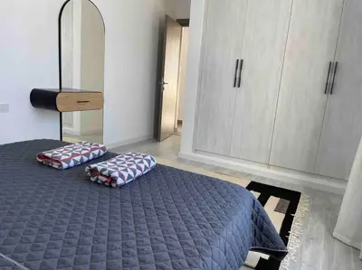 a bedroom with a bed with two pillows on it at 2 bd with private heated pool in Sholan 2 El Gouna in Hurghada