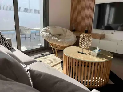 a living room with a couch and a table at 2 bd with private heated pool in Sholan 2 El Gouna in Hurghada