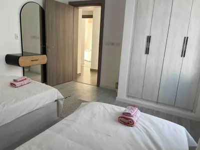 a bedroom with two beds with pink towels on them at 3bd with a private heated pool in Sholan 2 ElGouna in Hurghada